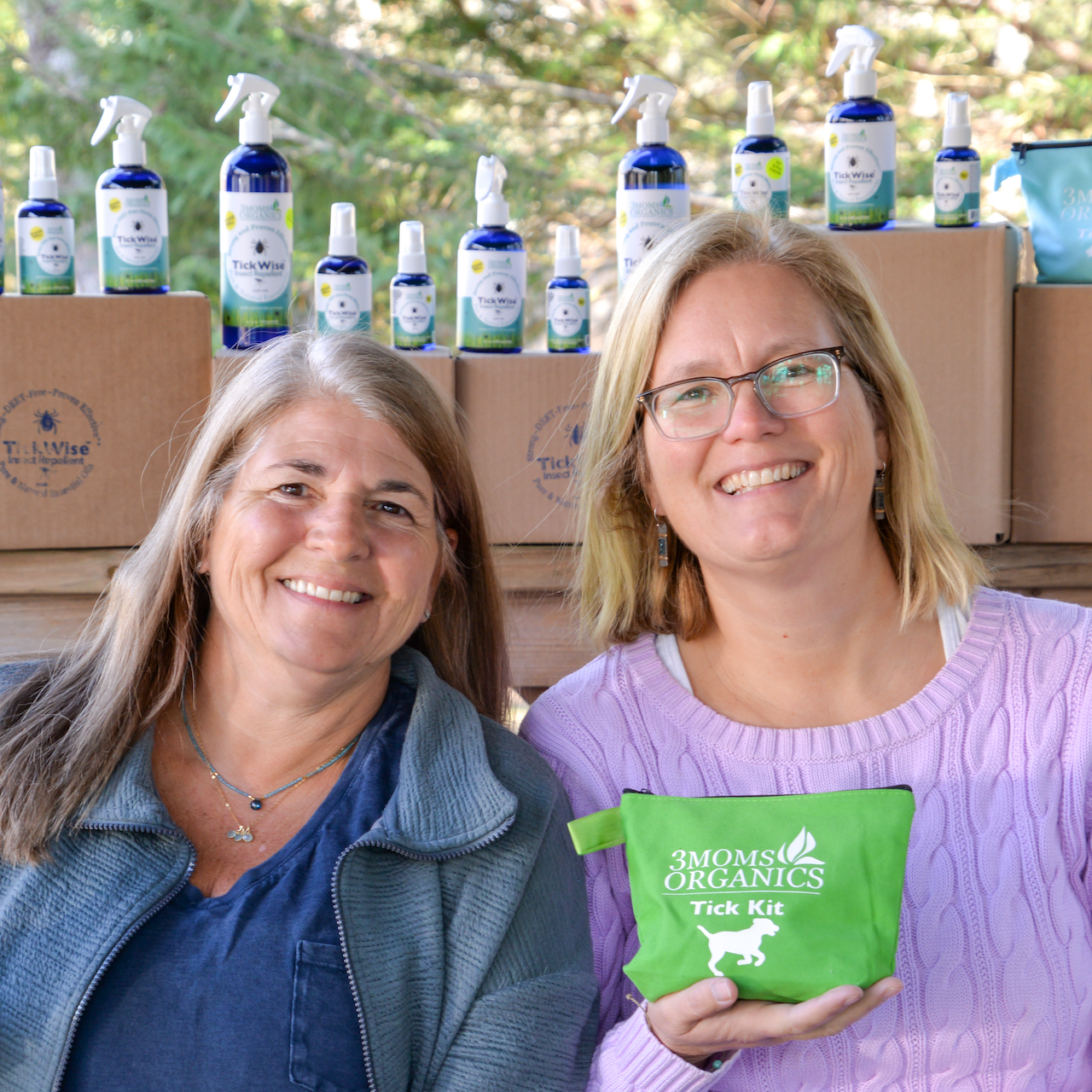 Two women standing in front of a product display stand 